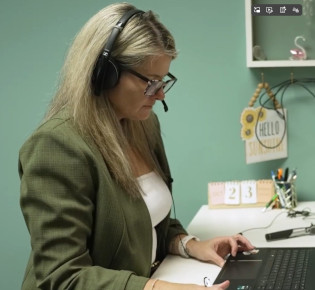 Anita Steinbach testing a client in the hearing booth